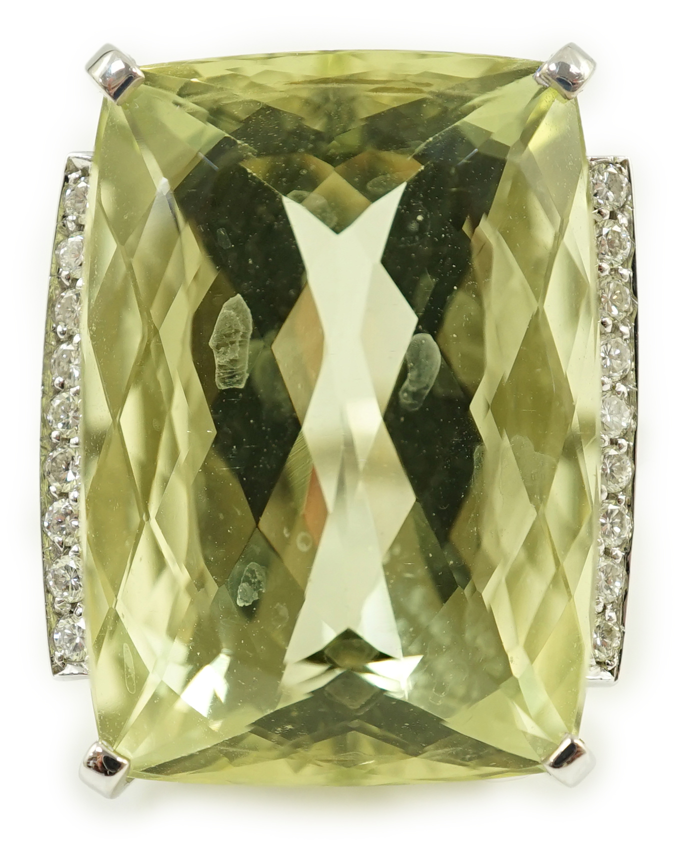 A modern white gold and shaped rectangular fancy cut pale green beryl set dress ring, with diamond chip setting